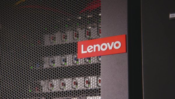 A red Lenovo logo on a mesh server rack door