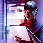 Brand image - person working on tablet with color streaks in background
