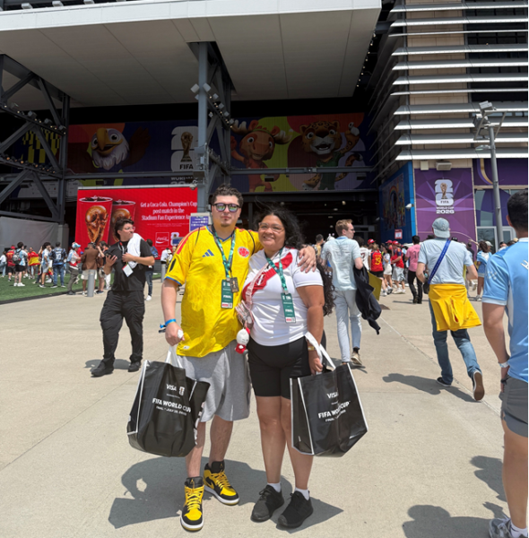 Christine and her boyfriend wearing their jerseys in front of the stadium